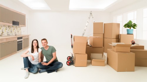 Movers handling desks and boxes in a Thornton Heath office move