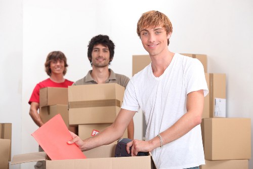 Careful lifting of boxes and household items during a local removal